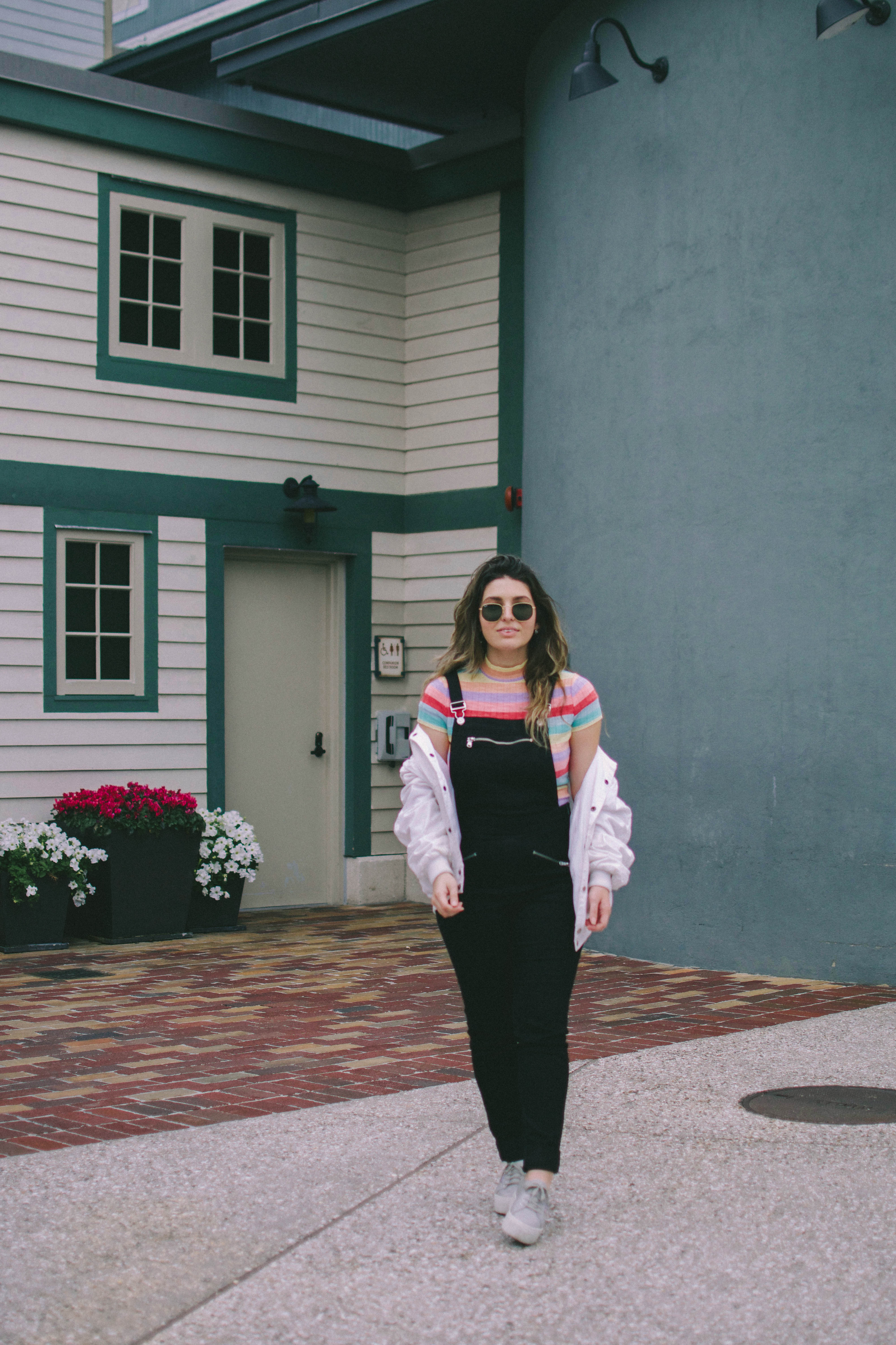 black jumpsuit overalls outfit and striped rainbow top