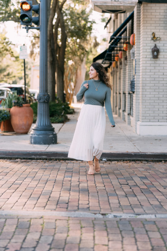 white pleated skirt outfit and turtleneck