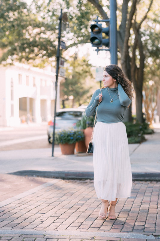 white pleated skirt and turtleneck outfit